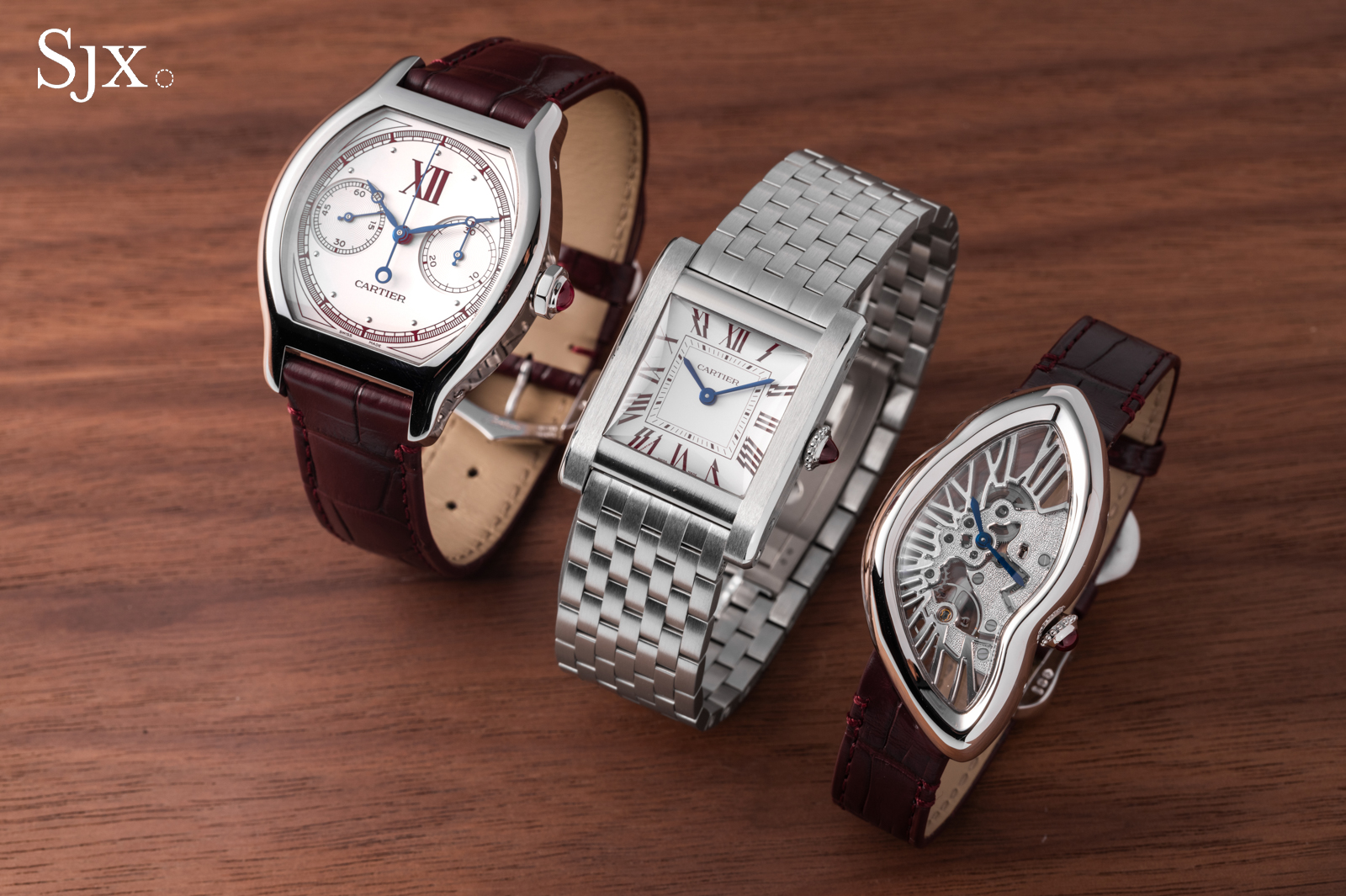Three platinum Cartier Prive Les Opus watches arranged side by side: the Tank Normale on the left, the Tortue Chronographe Monopoussoir in the middle, and the Crash Squelette on the right with burgundy printing
