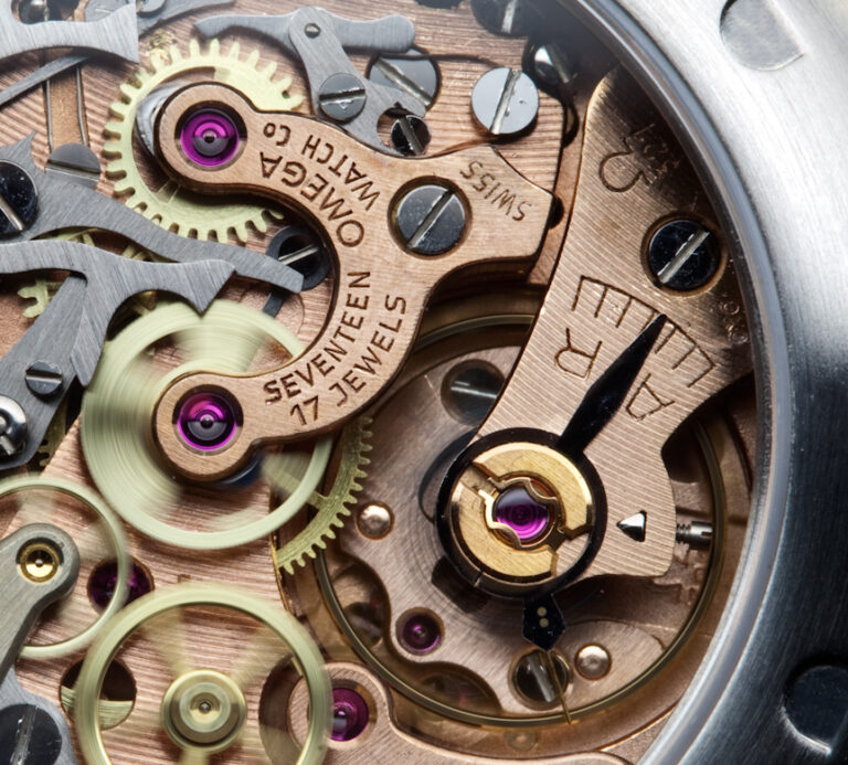 Omega Caliber 321 hand-wound column-wheel chronograph movement showing Geneva stripes finishing on bridges