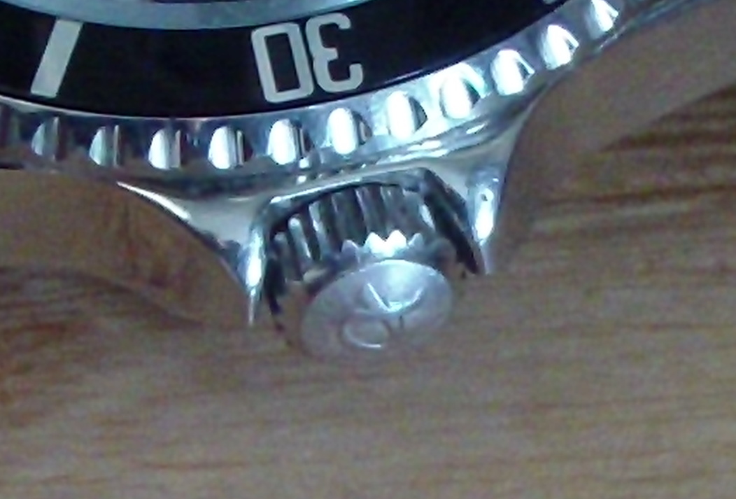 Close-up of a watch crown on the case side for water resistance