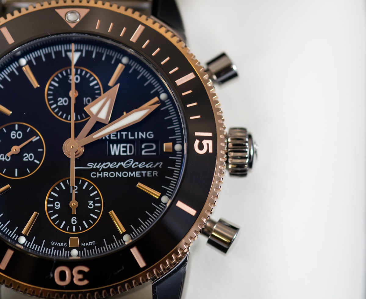 Hands winding the crown on a manual-wind dress watch
