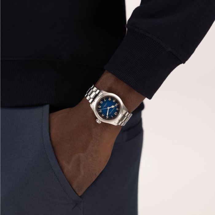 Wrist shot of the Hamilton Murph 38mm on stainless steel bracelet showing the comet blue dial