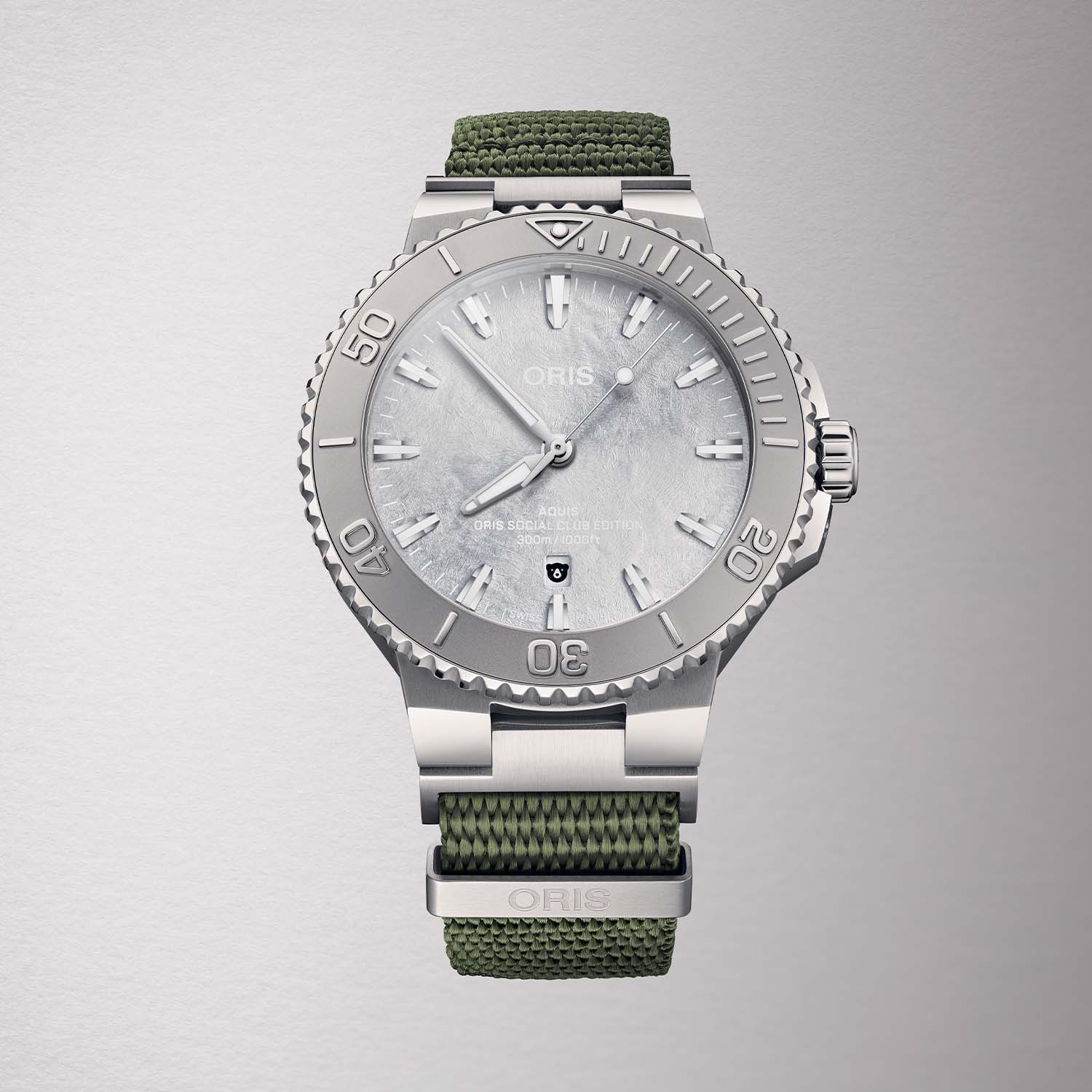 Frosted silver dial detail of Oris Social Club Edition II showing date window with Oris Bear