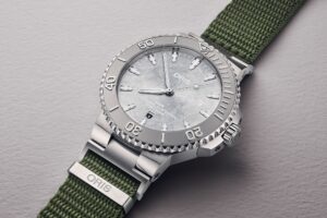 Oris Social Club Edition II Aquis Date Relief watch with frosted silver dial and olive green NATO strap