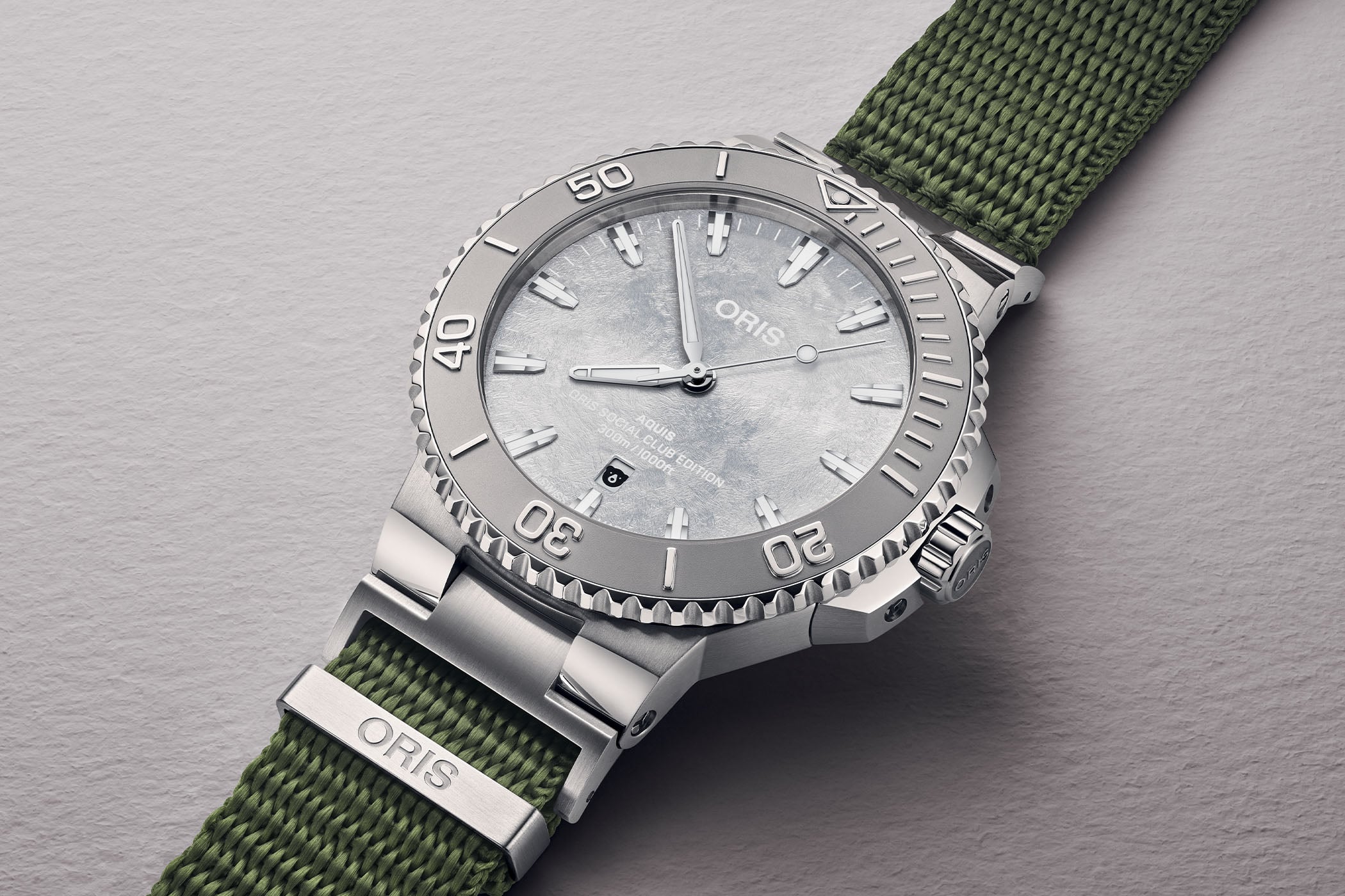 Oris Social Club Edition II Aquis Date Relief watch with frosted silver dial and olive green NATO strap