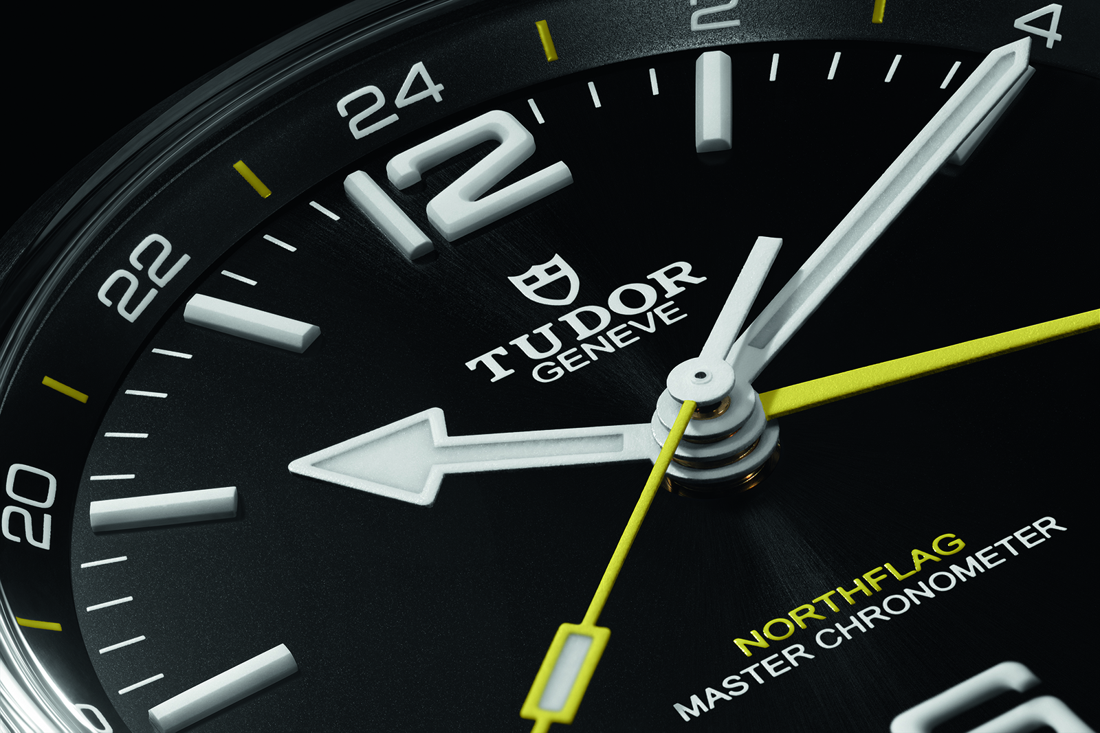 Tudor Northflag GMT dial close-up with ceramic luminous hour markers, yellow GMT hand and 24-hour flange